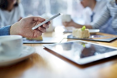 Woman using her smart phone in cafe